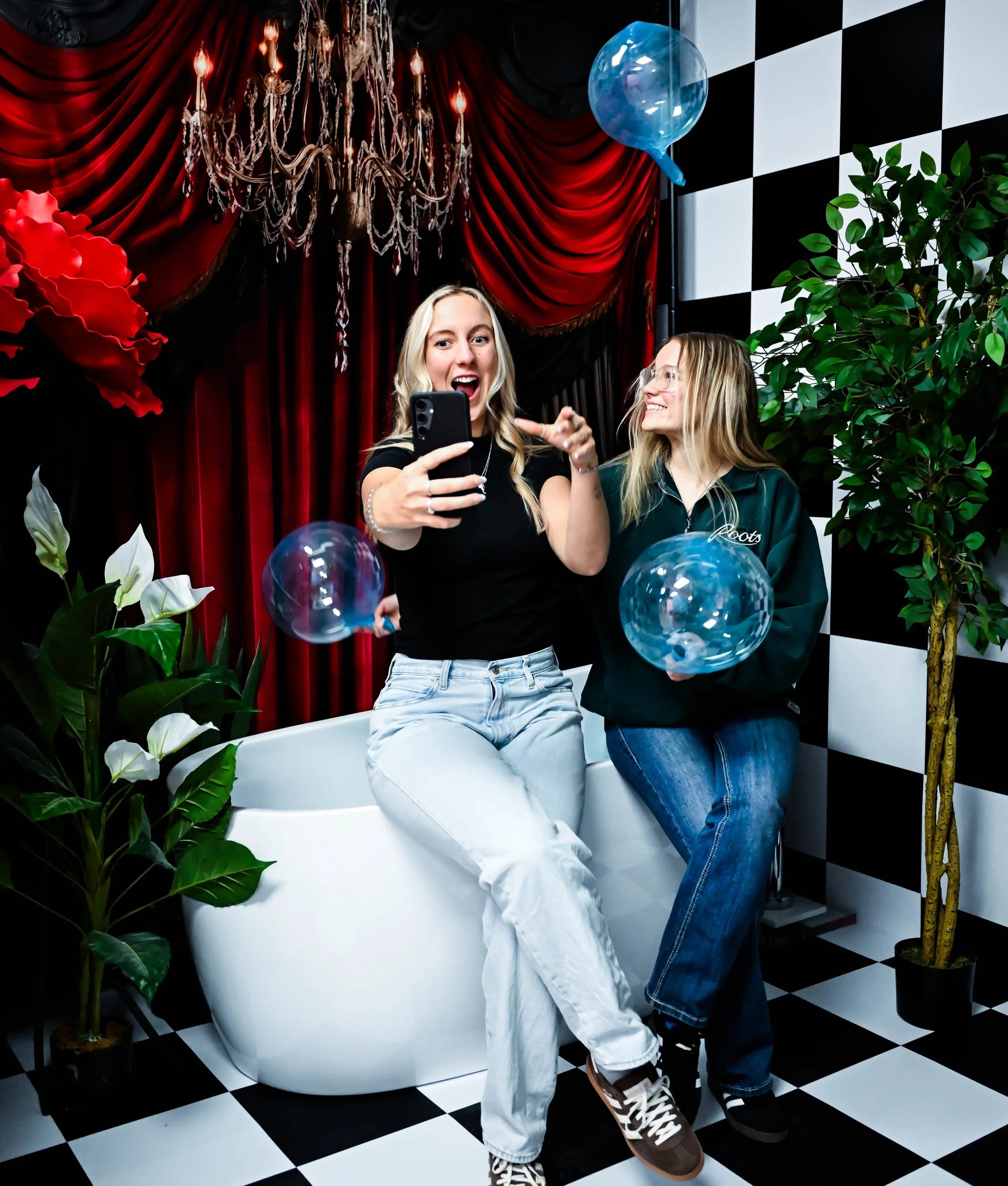 Person holding a camera remote clicker to take their own photos in a DIY photography studio